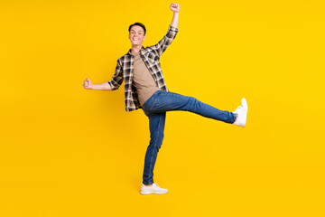 Obraz premium Photo of crazy funky guy rejoice achievement wear plaid shirt jeans footwear isolated yellow color background