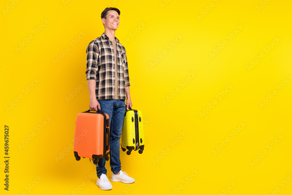 Canvas Prints Profile photo of positive guy carry two suitcase wear plaid shirt jeans sneakers isolated yellow color background