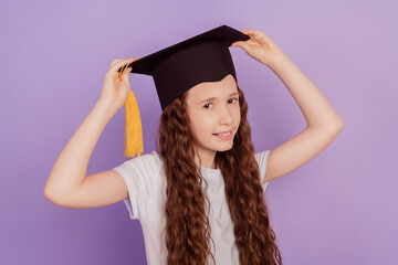 Portrait of smart successful girl wear bachelor headwear toothy smile on violet background