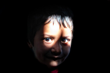 young kid in silence with sunlight on face close up shot at day from flat angle