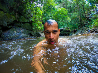 man bathing in natural waterfall in forests at morning from different angle