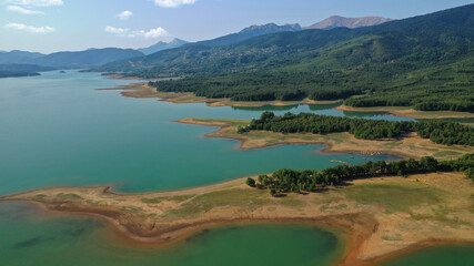 Aerial drone top down photo of beautiful artificial lake of Plastiras or Tavropos with wonderful nature and famous outdoor and water activities like canoe and water bike, Thessaly, Greece 