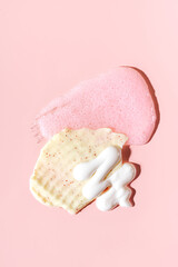 Various cosmetic mask, creams, serum, scrub and lotion smear on a pink background. Beauty texture. Sample of a cosmetic product.