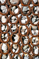 Texture of old rusty horseshoes - element of street decor.