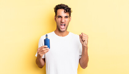 hispanic handsome man shouting aggressively with an angry expression. vaporizer concept