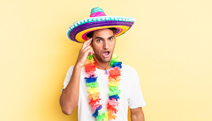 hispanic handsome man looking surprised, realizing a new thought, idea or concept. mexican party...