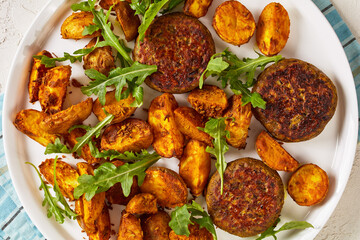 vegan lentil patties with baked potato and hummus