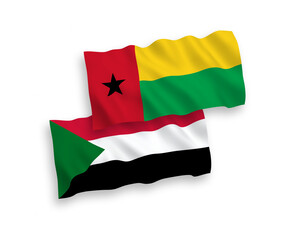 National vector fabric wave flags of Republic of Guinea Bissau and Sudan isolated on white background. 1 to 2 proportion.
