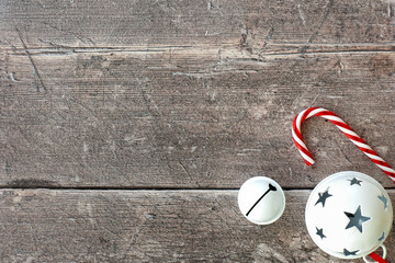 Candy Cane, Jingle Bells and Christmas Bauble on Brown Wood