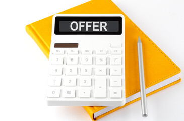 Calculator with the text OFFER on display on the notebook
