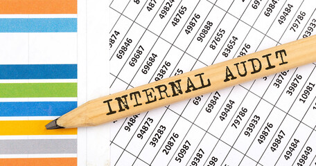 Business concept INTERNAL AUDIT text on the pencil on chart background