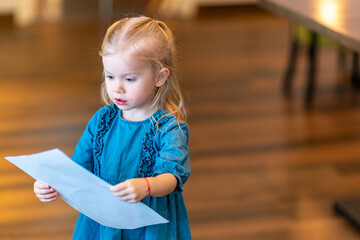 The girl shows the drawing to her mother.