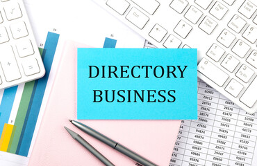 DIRECTORY BUSINESS text on blue sticker on chart with calculator and keyboard,Business concept