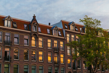 Dutch houses at sunset in the city of Amsterdam, Netherlands