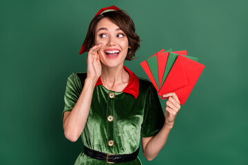Photo of dreamy lady hold fan envelop look empty space tell secret wear elf costume hat isolated...