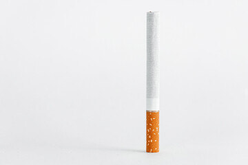 Single cigarette on white background. Copy Space