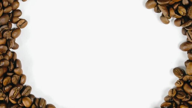 The coffee beans spin rotate quickly fast fly, dispart, splash to the sides with centrifugal coriolis force. The video is in reverse. Twist, create pattern, make design picture. Pressurized air wind.