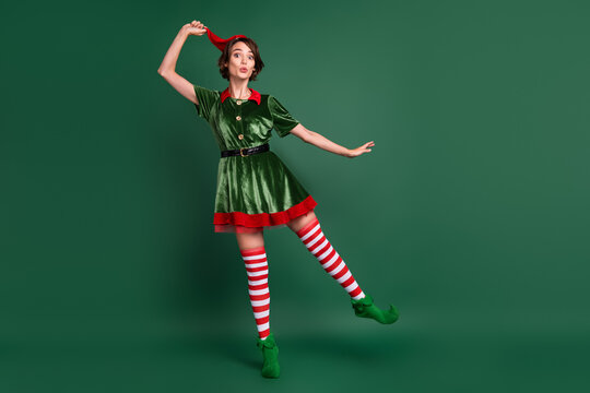 Full length body size view of attractive cheerful amazed funny girl elf fooling having fun isolated over green color background