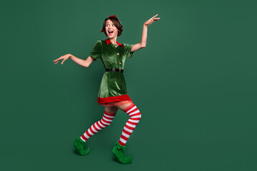 Full length body size view of attractive cheerful funny girl dancing having fun isolated over green...