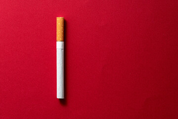 One cigarette evenly spaced on a dark red background.