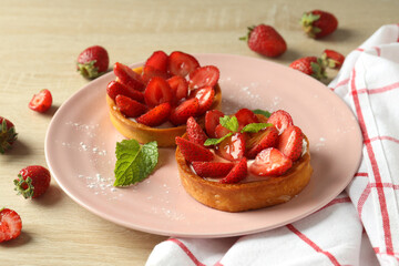 Concept of tasty food with strawberry tart on wooden table