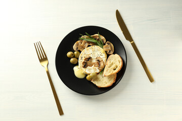 Concept of tasty food with grilled camembert on white wooden background