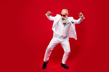 Full size photo of funky elder grey hair man dance wear eyewear white suit isolated on red color...