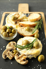 Concept of tasty food with grilled camembert on dark wooden background