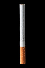 One cigarette in black background with close-up. Standing