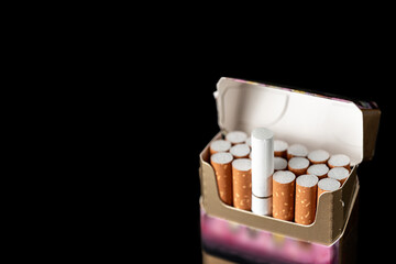 A pack of cigarettes, one of them is pulled out. Pack