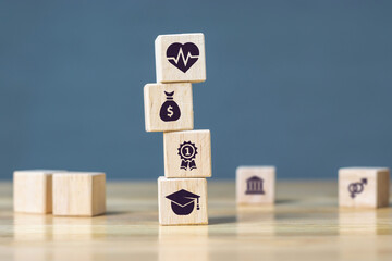 Wooden cube with money, success, education, health, basic concepts of human needs.