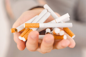 Concept of throwing a cigarette. Man holding a heap