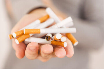 Concept of throwing a cigarette. Man holding a heap