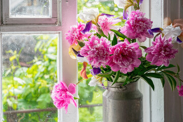 Old window and a bouquet of pink peonies