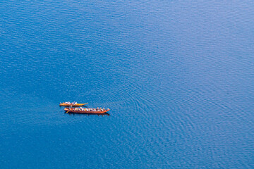 Pleasure boats with tourists on the surface of a mountain
