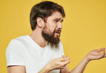 bearded man in white t-shirt yellow background studio emotion problems
