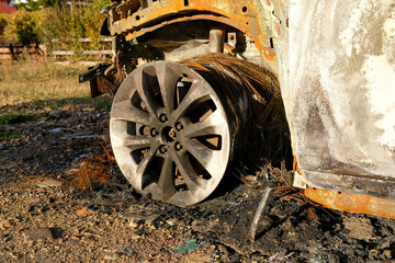 Details of the wheel of a burnt-out car. No one