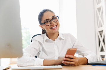 Happy mid aged businesswoman at the desk