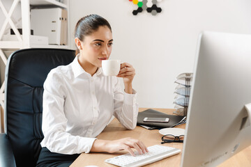 Happy mid aged businesswoman at the desk