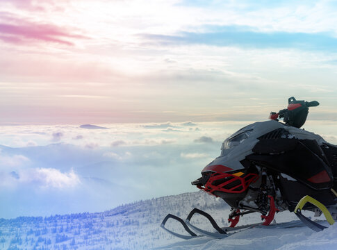 a sports snowmobile is waiting for its driver at the start in the early morning. the concept of advertising recreation and travel on snow bikes. high quality photos