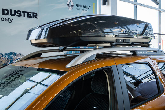 Renault Duster SUV in gold color with roof rack at Renault showroom. Close-up of car roof rack. Renault car dealership in Mega Adygea. Krasnodar, Russia - September 12, 20211