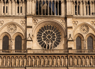 Fototapeta na wymiar Beautiful Ornaments And The Rosette On The West Facade Of The Notre Dame Cathedral In Paris France On A Beautiful Spring Day