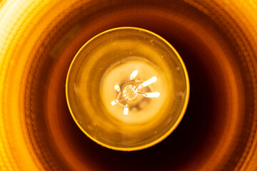 Vintage hanging light bulb on a dark background. Loft style.