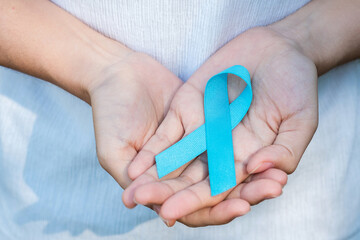 November Prostate Cancer Awareness month, woman holding Blue Ribbon for supporting people living...