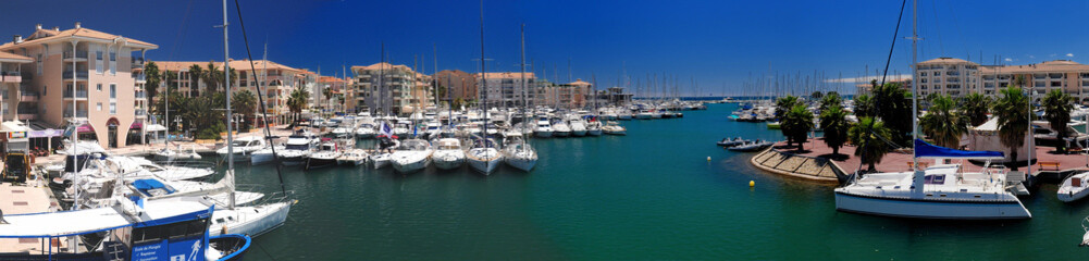 Fototapeta na wymiar Luxurious Boats In The Yachting Harbour Of Frejus In Provence France On A Beautiful Summer Day With A Clear Blue Sky
