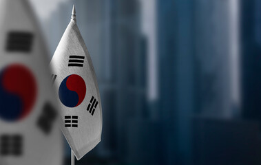 Small flags of South Korean on a blurry background of the city