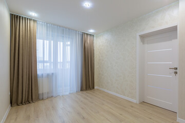 Interior photo of a room without furniture after renovation in light colors