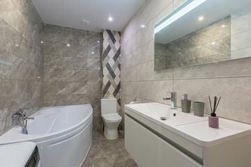 bathroom interior, in a small smart apartment, bath and washing machine with toilet