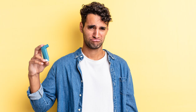 hispanic handsome man feeling sad and whiney with an unhappy look and crying. asthma concept