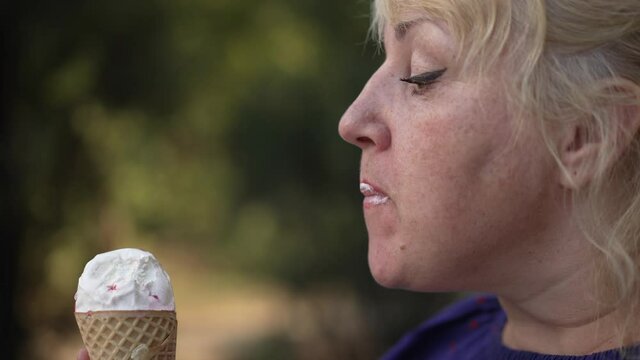 Woman eating Ice-cream at the street